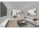 Open living room with a view into the dining area and features a comfy sofa at 381 Paper Woods Dr, Lawrenceville, GA 30046
