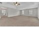 Spacious main bedroom with neutral walls and carpet, ceiling fan, and ample natural light at 381 Paper Woods Dr, Lawrenceville, GA 30046