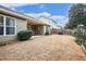 Spacious backyard with a covered patio, lush green lawn, and privacy fence at 173 Mill Creek Dr, Canton, GA 30115