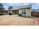 This backyard features a covered patio, a large lawn, and a wood fence at 173 Mill Creek Dr, Canton, GA 30115