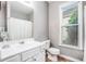 Bathroom features a large white vanity, a sink, and a window overlooking the greenery outside at 173 Mill Creek Dr, Canton, GA 30115