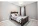 Bedroom features neutral walls, dark wood bed, a ceiling fan, and cozy carpet at 173 Mill Creek Dr, Canton, GA 30115