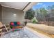 Relaxing covered patio with stylish outdoor furniture and a view of the private backyard at 173 Mill Creek Dr, Canton, GA 30115