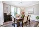 This dining room with modern light fixtures and a large dark wood table offers a cozy spot to dine at 173 Mill Creek Dr, Canton, GA 30115