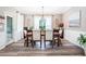 Dining room features hardwood floors, a wooden table, and four chairs with a view out the windows at 173 Mill Creek Dr, Canton, GA 30115