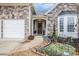 Welcoming front entrance with a decorative wreath, landscaped garden, and charming 'Welcome' sign at 173 Mill Creek Dr, Canton, GA 30115