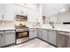 Well-equipped kitchen featuring stainless steel appliances, modern cabinetry, and stylish countertops at 173 Mill Creek Dr, Canton, GA 30115