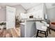 Modern kitchen area featuring white cabinets, stainless steel appliances, and a convenient breakfast bar at 173 Mill Creek Dr, Canton, GA 30115