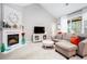 Bright and spacious living room with a cozy fireplace, neutral decor, and ample seating at 173 Mill Creek Dr, Canton, GA 30115