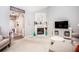This living room offers neutral walls, a cozy fireplace and mantle, and plush furniture at 173 Mill Creek Dr, Canton, GA 30115