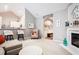 Living room with a fireplace, vaulted ceilings, neutral colors, and a view of the kitchen at 173 Mill Creek Dr, Canton, GA 30115