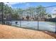 Community tennis court featuring benches and fence at 173 Mill Creek Dr, Canton, GA 30115