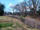 Partially fenced backyard with a walking path, perfect for enjoying the outdoors at 650 Kingston Highway, Kingston, GA 30145