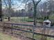 Small creek with wooden fence and daffodils at 650 Kingston Highway, Kingston, GA 30145