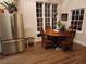 Cozy dining area with a round wooden table and chairs near a large window at 650 Kingston Highway, Kingston, GA 30145