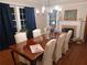 Formal dining room with a large table, chandelier, and hardwood floors at 650 Kingston Highway, Kingston, GA 30145