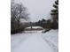 Long driveway leading to stone house covered in snow at 650 Kingston Highway, Kingston, GA 30145