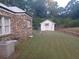 Stone house side with detached shed and yard at 650 Kingston Highway, Kingston, GA 30145