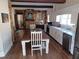 Bright kitchen featuring white cabinets, stone wall, and a farmhouse table at 650 Kingston Highway, Kingston, GA 30145