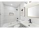 Bright bathroom featuring modern fixtures, stylish tile, tub, and vanity with mirror and black hardware at 1288 Almont Sw Dr, Atlanta, GA 30310