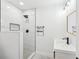 The stylish bathroom features modern fixtures, marble tile, and a glass enclosed shower for a sleek, contemporary design at 1288 Almont Sw Dr, Atlanta, GA 30310