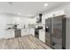 Modern kitchen featuring stainless steel appliances, granite countertops, subway tile backsplash, and white cabinets at 1288 Almont Sw Dr, Atlanta, GA 30310