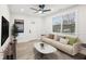 Bright living room featuring a ceiling fan, many windows, a comfortable couch, and a modern coffee table at 1288 Almont Sw Dr, Atlanta, GA 30310
