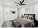 Comfortable main bedroom leading to the primary bathroom, featuring an art piece and bench at 1288 Almont Sw Dr, Atlanta, GA 30310