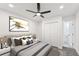 Bright main bedroom featuring a ceiling fan, a large window, and closet doors at 1288 Almont Sw Dr, Atlanta, GA 30310
