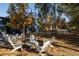 Outdoor seating area features an inviting arrangement of white Adirondack chairs, picnic tables, and shade trees at 1288 Almont Sw Dr, Atlanta, GA 30310