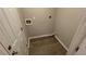 Small laundry room with vinyl flooring at 206 Sherwood Loop, Mcdonough, GA 30253