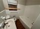 White tiled bathroom with tub and vanity at 2043 Chicago Nw Ave, Atlanta, GA 30314
