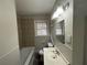 Clean bathroom with a tub, sink, and window at 2669 Blount St, Atlanta, GA 30344