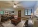 Comfortable living room with a ceiling fan, a sofa, two armchairs, and a coffee table with flower decor at 336 Shady Lane Cir, Canton, GA 30115