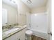 Updated bathroom with granite countertop, white cabinets, and a bathtub at 1129 Winston Dr, Decatur, GA 30032