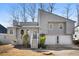 Gray two-story house with attached two-car garage and landscaping at 1358 Millstream Trl, Lawrenceville, GA 30044