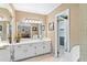 Bathroom boasts double vanity, sink, cabinets, mirror, and an adjoining room with white accents at 837 Pine Ridge Dr, Lawrenceville, GA 30043