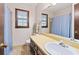 Bathroom shows window, a blue shower curtain, vanity, and toilet at 837 Pine Ridge Dr, Lawrenceville, GA 30043