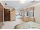 Bedroom features large closet, window seating, decorative dresser and mirror, and carpeted floor at 837 Pine Ridge Dr, Lawrenceville, GA 30043