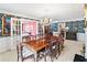 Formal dining room with chandelier, floral wallpaper, and a large wooden table and chairs at 837 Pine Ridge Dr, Lawrenceville, GA 30043