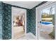 A quaint foyer with patterned wallpaper leads to a home office and in-ground pool at 837 Pine Ridge Dr, Lawrenceville, GA 30043