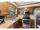 Charming kitchen features wood cabinets, brick backsplash, stainless steel appliances, and wood-look countertop at 837 Pine Ridge Dr, Lawrenceville, GA 30043