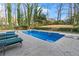 A backyard pool features a diving board and ladder for seamless enjoyment at 837 Pine Ridge Dr, Lawrenceville, GA 30043