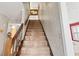 Carpeted staircase with wood railing and trim, leading to the upper level of the home at 837 Pine Ridge Dr, Lawrenceville, GA 30043