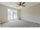 Spacious bedroom with ceiling fan and window at 235 Ridge Bluff Ln, Suwanee, GA 30024