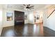 Spacious living room with dark hardwood floors, fireplace, and ceiling fan at 3849 Sweet Iris Cir, Loganville, GA 30052