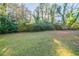 Large backyard with grassy area and mature trees at 1583 Tanager Cir, Decatur, GA 30032