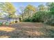 Large backyard with partially cleared and grassy areas at 1583 Tanager Cir, Decatur, GA 30032