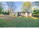 Home's rear elevation and expansive grassy backyard at 1583 Tanager Cir, Decatur, GA 30032