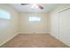 Bright bedroom with ceiling fan, carpet, and sliding door closet at 1583 Tanager Cir, Decatur, GA 30032